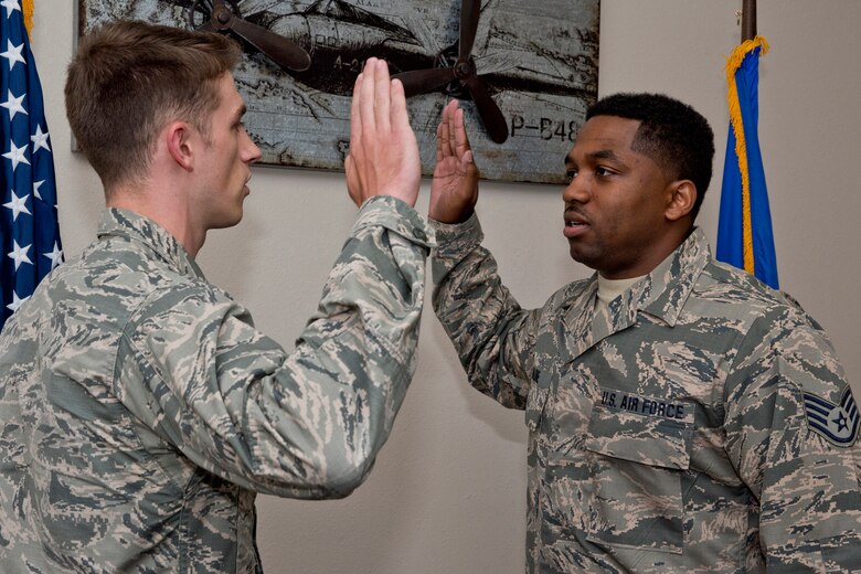 U.S. Air Force 2nd Lt. Isaac Hood, executive officer, 19th Maintenance Group, administers the oath of reenlistment to U.S. Air Force Reserve Staff Sgt. Corey Malone, plans and scheduling, 913th Maintenance Squadron, at Little Rock Air Force Base, Ark., June 27, 2018.