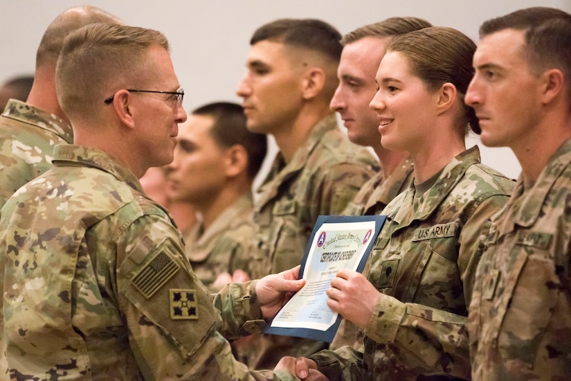 U.S. Army Maj. Gen. David C. Hill, U.S. Army Central's deputy commanding general, presents a certificate of appreciation to Spc. Emma L. Gebrosky, a competitor in USARCENT's Best Warrior Competition. Each competitor received a certificate in recognition of their dedication and hard work throughout the three days of the competition.