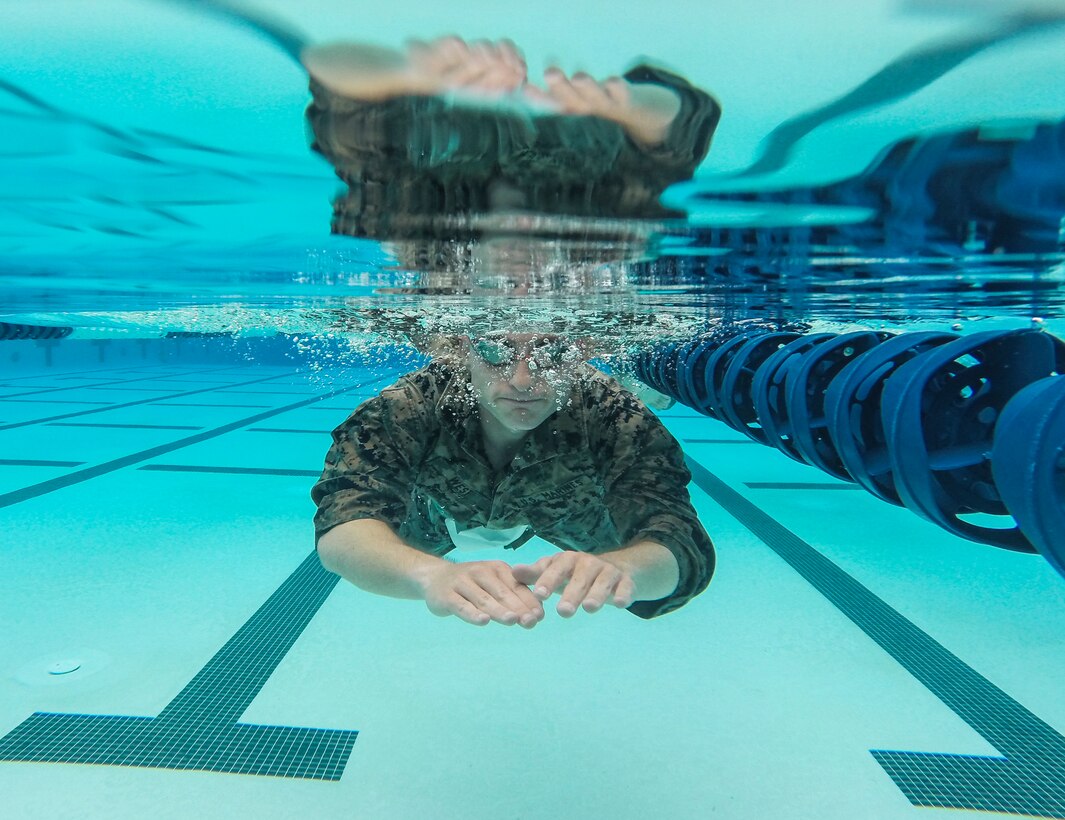 Sgt. Philip M. West with Headquarters and Headquarters Squadron, completes the 500 meter swim portion of the “Aquathon” at Marine Corps Air Station Miramar, Calif., June 29. Headquarters and Headquarters Squadron hosted the Aquathon as June’s Warrior Challenge, a run-swim-run team competition between active duty service members at MCAS Miramar. (U.S. Marine Corps photo by Cpl. Becky Cleveland)