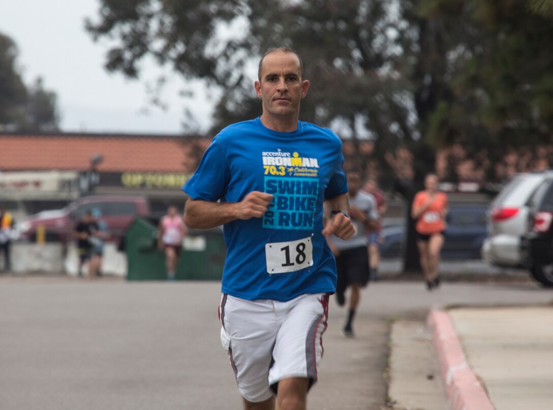 Lt. Col. Michael A. Spears, commanding officer of Headquarters and Headquarters Squadron, completes the two mile run during the “Aquathon” at Marine Corps Air Station Miramar, Calif., June 29. Headquarters and Headquarters Squadron hosted the Aquathon as June’s Warrior Challenge, a run-swim-run team competition between active duty service members at MCAS Miramar. (U.S. Marine Corps photo by Cpl. Becky Cleveland)