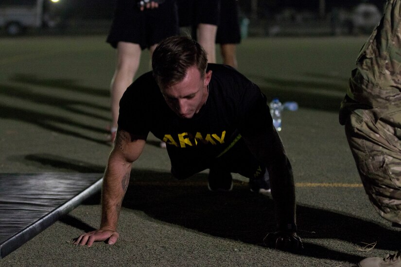 U.S. Army Spc. Cameron Gaylor, a military policeman assigned to the 202nd Military Police Company, attached to U.S. Army Central, prepares for the push-up event of the Army Physical Fitness Test at USARCENT's Best Warrior Competition at Camp Arifjan, Kuwait, June 28, 2018. The purpose of the Best Warrior Competition is to promote morale, improve cohesion between units and reinforce the importance of individual excellence within the Army profession.