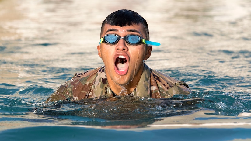 U.S. Army Spc. Julio Tepehua-Tello, a culinary specialist assigned to the 665th Engineer Utilities Detachment, U.S. Army Central, surfaces to breathe during the 100-meter swim event of USARCENT's Best Warrior Competition at Camp Arifjan, Kuwait, June 28, 2018. Events like the 100-meter swim are a valuable training opportunity for Soldiers to experience challenges outside of what they normally face.