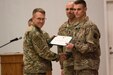 U.S. Army Maj. Gen. David C. Hill, U.S. Army Central's deputy commanding general, presents an award to Spc. Jacob T. Randall, the enlisted Soldier winner of USARCENT's Best Warrior Competition. The purpose of the Best Warrior Competition is to promote morale, improve cohesion between units and reinforce the importance of individual excellence within the Army profession.