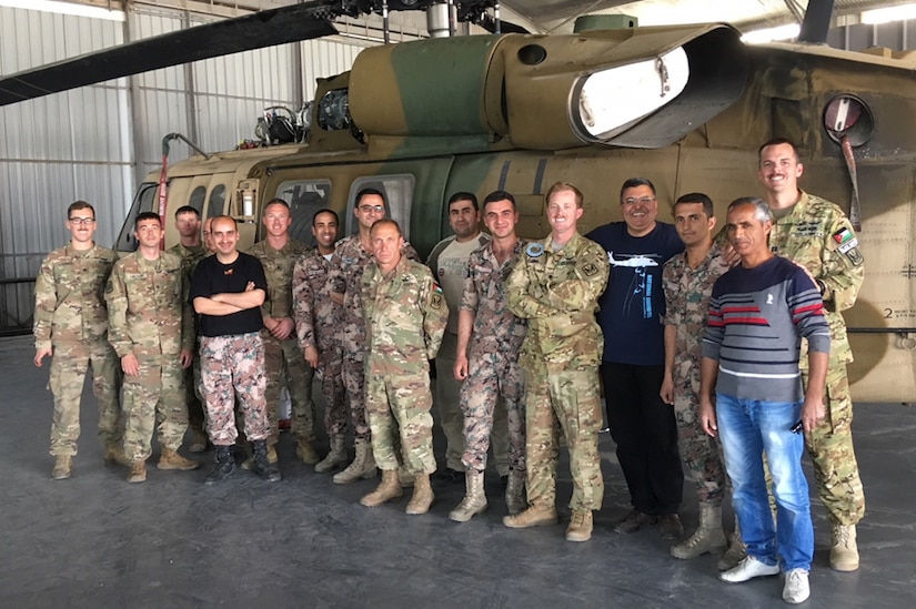 Soldiers with the 248th Aviation Support Battalion and the 1st Battalion, 244th Aviation Regiment (Assault) – units of the 449th Combat Aviation Brigade – stand in front of a Jordanian UH-60A Black Hawk May 10, 2018 with members of the Royal Jordanian Air Force. The soldiers worked side-by-side over a two-month period facilitating different aspects of aviation maintenance. During their mission, the 248th ASB and the 1-244 AHB made up an eight-man team that worked with the RJAF team to focus on phase maintenance inspections of UH-60A Black Hawks, UH-60M Black Hawk maintenance, and aviation maintenance management training to help strengthen the RJAF’s mission readiness and interoperability.