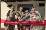 (From left) Col. Kevin Nemelka, Brig. Gen. Jeffrey Johnson, Brig. Gen. Erik Torring, Lt. Col. Jacque Parker, Air Force Maj. David Temple and Maj. Andrea Henderson cut the ribbon to the new Sports Medicine Rehabilitation Facility and Hospital Recovery Kennels at the Lt. Col. Daniel E Holland Military Working Dog Hospital June 28. The new facility provides flooring and lighting more suited to protect post-operative patients and minimize their stress. It includes a quiet room, large exercise area and an aquatic therapy room.