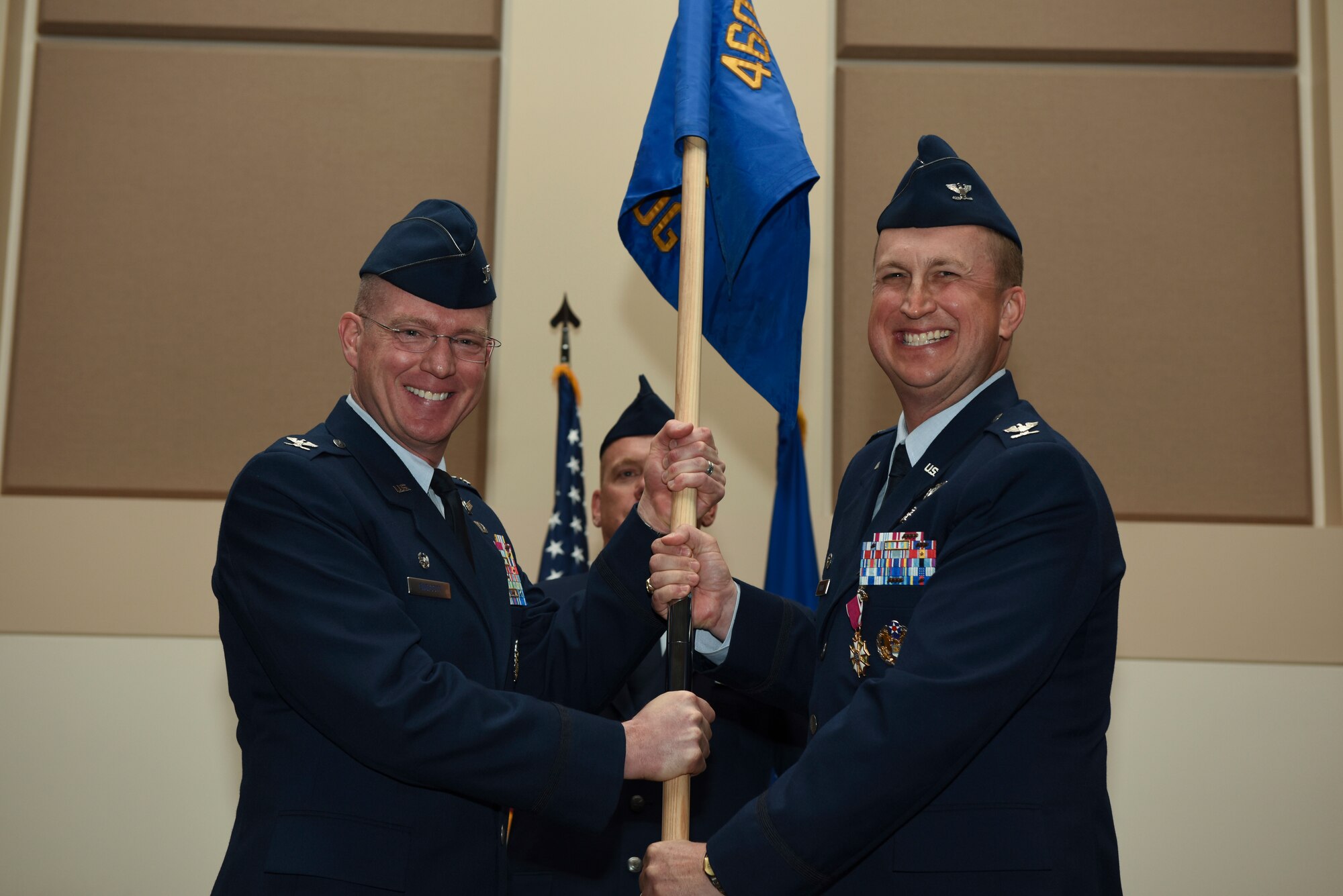 2-	Col. Troy Endicott, 460th Space Wing commander, receives the guidon from Col. Matthew Hanson, 460th Medical Group outgoing commander, June 29, 2018, on Buckley Air Force Base, Colorado. The exchanging of the guidon symbolizes the official change of command. (U.S. Air Force photo by Airman 1st Class Michael D. Mathews)
