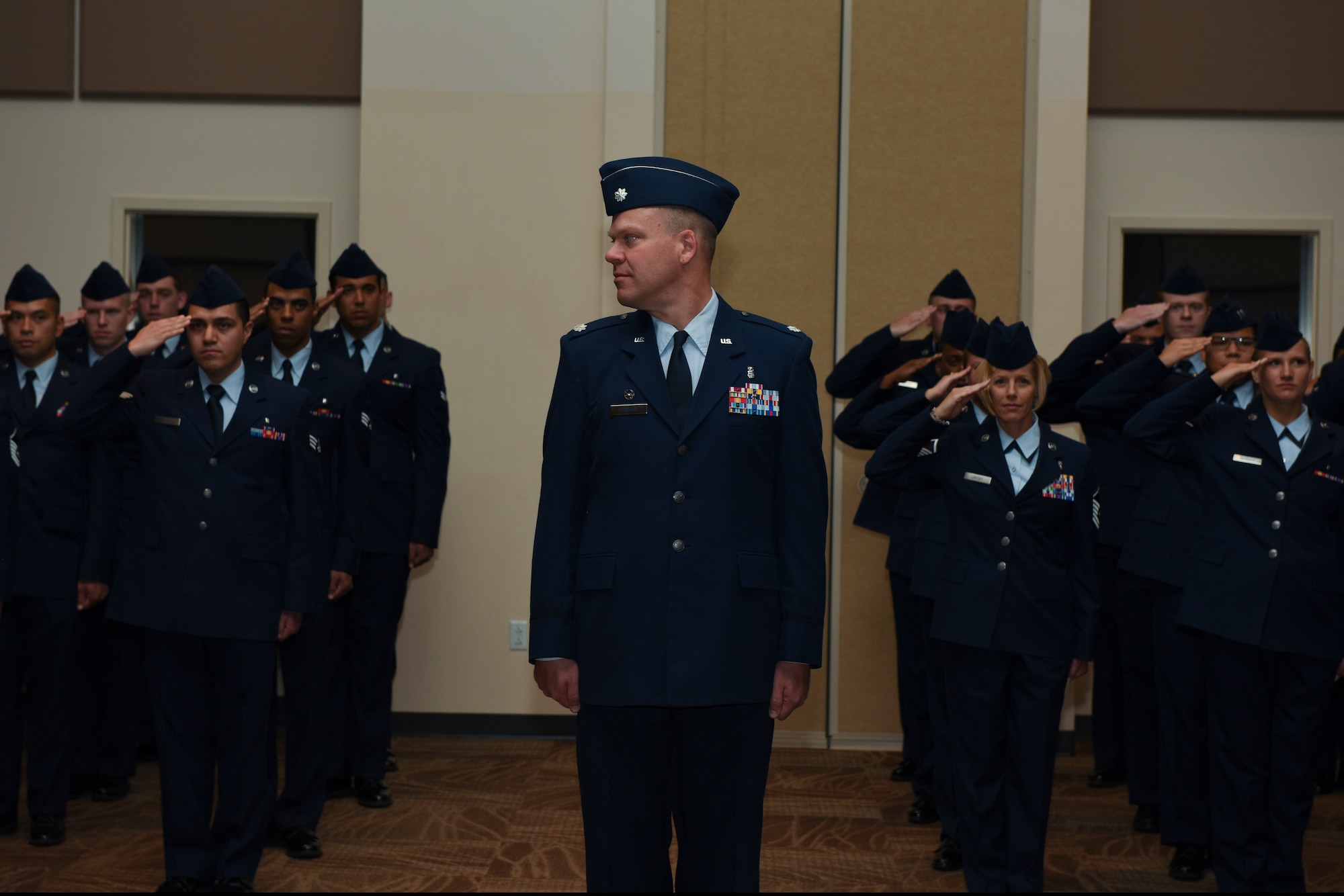 Airmen from the 460th Medical Group render a salute to Lt. Col. Shannon Phares, 460th MDG commander, June 29, 2018, on Buckley Air Force Base, Colorado. Salutes are rendered to both the incoming and outgoing commanders to symbolize change of authority from one commander to another. (U.S. Air Force photo by Airman 1st Class Michael D. Mathews)