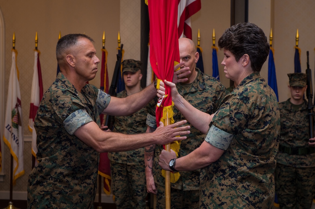Maj. Gen. Loretta Reynolds, off-going commanding general, Marine Forces Cyberspace Command, passes the colors to on-coming commanding general, Maj. Gen. Matthew Glavy during a change of command ceremony at Fort George G. Meade, Maryland, July 2, 2018. During the ceremony, Reynolds was promoted to lieutenant general and will assume the duties of Deputy Commandant for Information, July 3, 2018.