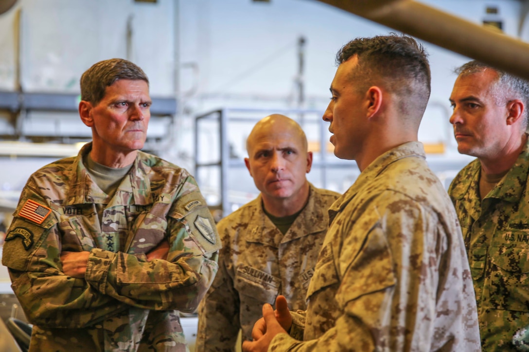 U.S. Army Gen. Joseph Votel, commander, U.S. Central Command,  speaks with U.S. Marine Corps Sgt. Mason McLaughlin aboard the Wasp-class amphibious assault ship USS Iwo Jima (LHD 7), June 22, 2018. Votel, Vice Adm. Scott Stearney, commander, U.S. Naval Forces Central Command, and other distinguished visitors took a tour of Iwo Jima and spoke with crew members and Marines with the 26th Marine Expeditionary Unit, who are currently deployed to the U.S. 5th Fleet of operations in support of maritime security operations to reassure allies and partners and preserve the freedom of navigation and the free flow of commerce in the region. (U.S. Marine Corps photo by Cpl. Jon Sosner/Released)