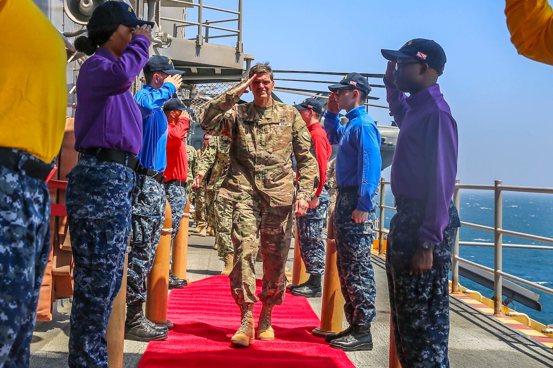 U.S. Army Gen. Joseph Votel, commander, U.S. Central Command,  salutes Sailors as he is welcomed aboard the Wasp-class amphibious assault ship USS Iwo Jima (LHD 7), June 22, 2018. Votel, Vice Adm. Scott Stearney, commander, U.S. Naval Forces Central Command, and other distinguished visitors took a tour of Iwo Jima and spoke with crew members and Marines with the 26th Marine Expeditionary Unit, who are currently deployed to the U.S. 5th Fleet of operations in support of maritime security operations to reassure allies and partners and preserve the freedom of navigation and the free flow of commerce in the region. (U.S. Marine Corps photo by Cpl. Jon Sosner/Released)