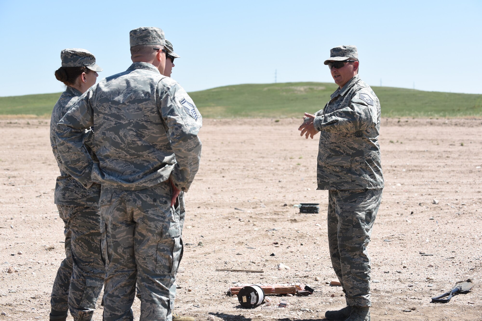 90th Civil Engineer Squadron leadership visit the Explosive Ordnance Disposal range to observe a portion of the three-day field training June 27, 2018, F.E. Warren Air Force Base, Wyo. The training encompassed various tools and techniques within the EOD career field and allowed the Airmen to experience simulated real-world scenarios. (U.S. Air Force photo by Airman 1st Class Abbigayle Wagner)