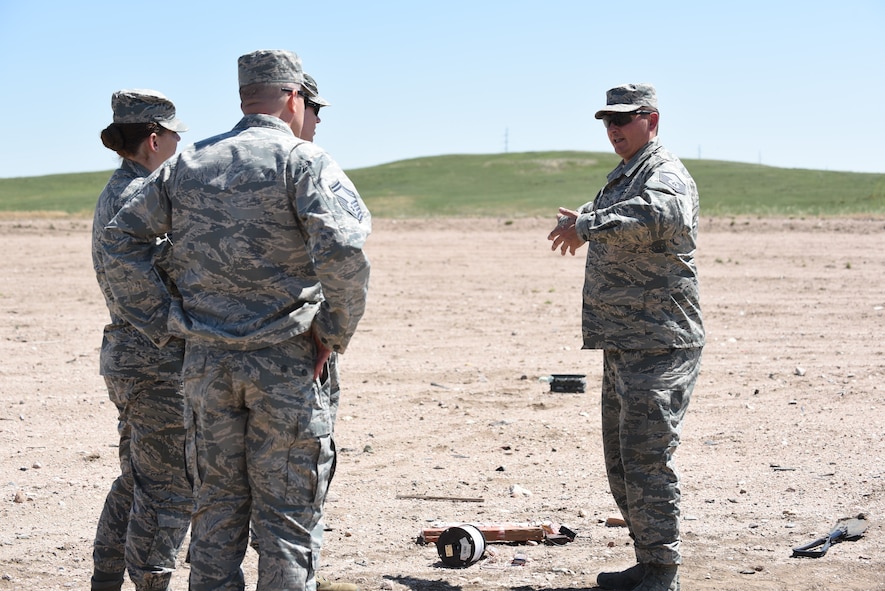 90th Civil Engineer Squadron leadership visit the Explosive Ordnance Disposal range to observe a portion of the three-day field training June 27, 2018, F.E. Warren Air Force Base, Wyo. The training encompassed various tools and techniques within the EOD career field and allowed the Airmen to experience simulated real-world scenarios. (U.S. Air Force photo by Airman 1st Class Abbigayle Wagner)