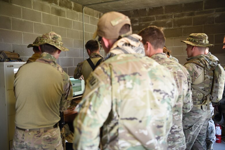 The 90th Civil Engineer Squadron Explosive Ordnance Disposal flight Airmen, participating in a three-day field training exercise, watch a live stream of the EOD range in anticipation of a 25-pound C4 explosion June 27, 2018, at the EOD range, F.E. Warren Air Force Base, Wyo. The detonation was one of many exercises throughout the training, providing the Airmen with infrastructure knowledge and current counter- Improvised Explosive Device techniques. (U.S. Air Force photo by Airman 1st Class Abbigayle Wagner)