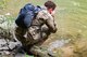 U.S. Air Force Maj. Joseph Shamess cools off in the Little Coal River while performing Survival, Evasion, Resistance and Escape (SERE) training June 2, 2018 at Alum Creek, W.Va.