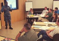 IMAGE: NSWC Dahlgren Division Commanding Officer Capt. Godfrey 'Gus' Weekes briefs new first-line supervisors from divisions across the Naval Warfare Centers on the first day of their five-day Propel training course. "I applaud the fact that you applied (for the supervisory position) and are showing others that it is important to be outside of your comfort zone and to contribute as leaders," said Weekes, who recommended a book he just finished reading called 'Neptune's Inferno' about the World War II naval battle for Guadalcanal. "If you need anything to get your mind sharper on why we do what we do, and the need to ensure that the Fleet understands the way the combat system actually works - the capability it actually provides - read or listen to that book."

Propel provides an introductory level awareness of the Warfare Center expectations for supervisors while increasing their collaboration and understanding of Warfare Center operations. A tour - scheduled this week for a deeper look into the work being done at Dahlgren - will provide an opportunity for further collaboration and sharing of best practices.