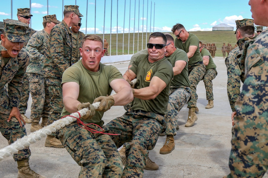 Marines pull a rope during a tug of war match.