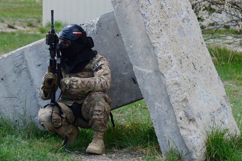 An Airman with the 841st Missile Security Forces Squadron takes cover during a training scenario June 24, 2018, at Fort Harrison, Mont.