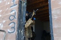 An Airman with the 841st Missile Security Forces Squadron locks on to a target while keeping cover during a training scenario June 24, 2018, at Fort Harrison, Mont.