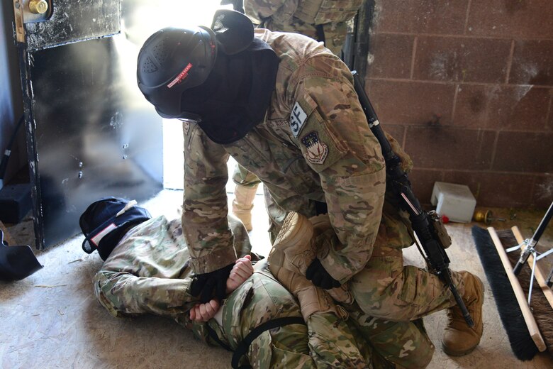 An Airman with the 841st Missile Security Forces Squadron pins down an opposing member during a training scenario June 24, 2018, at Fort Harrison, Mont.