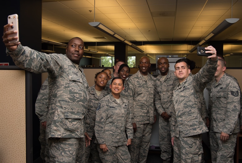 Chief Master Sgt. of the Air Force Kaleth O. Wright takes a selfie with Airmen in in the 440th Supply Chain Operations Squadron at Joint Base Langley-Eustis, Va. June 28, 2018. At the end of his tour Wright held an all call for the Airmen of JBLE where he discussed his priorities of resilience, leadership and training. (U.S. Air Force photo by Senior Airman Tristan Biese)
