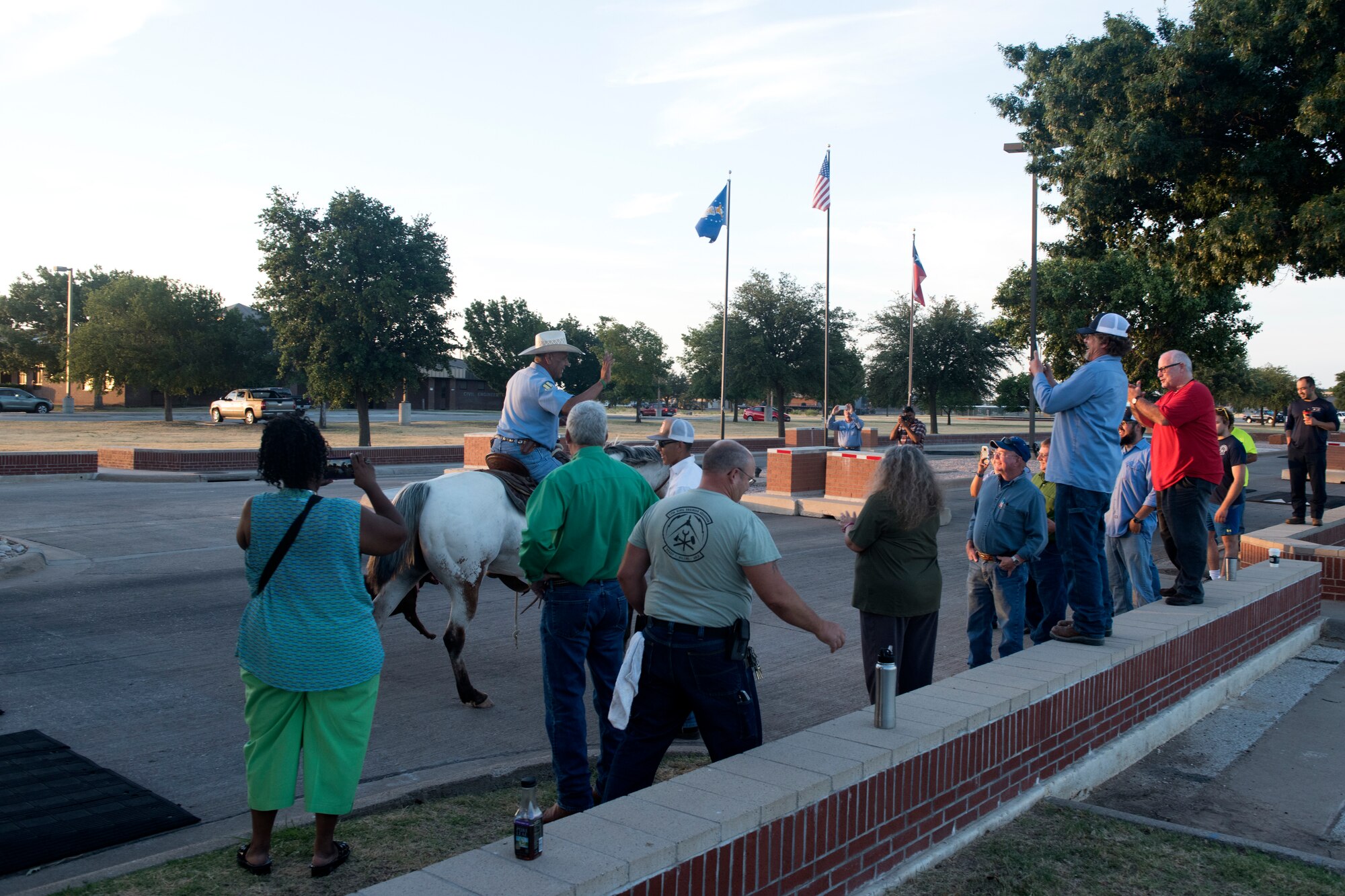 17th Civil Engineer Squadron heavy equipment operator, George Nava arrives at Goodfellow Air Force Base, Texas, June 29, 2018. Riding his horse to work was on Nava’s bucket list, so on his last day he got the approval and began the day in style. (U.S. Air Force photo by Airman 1st Class Zachary Chapman/Released)