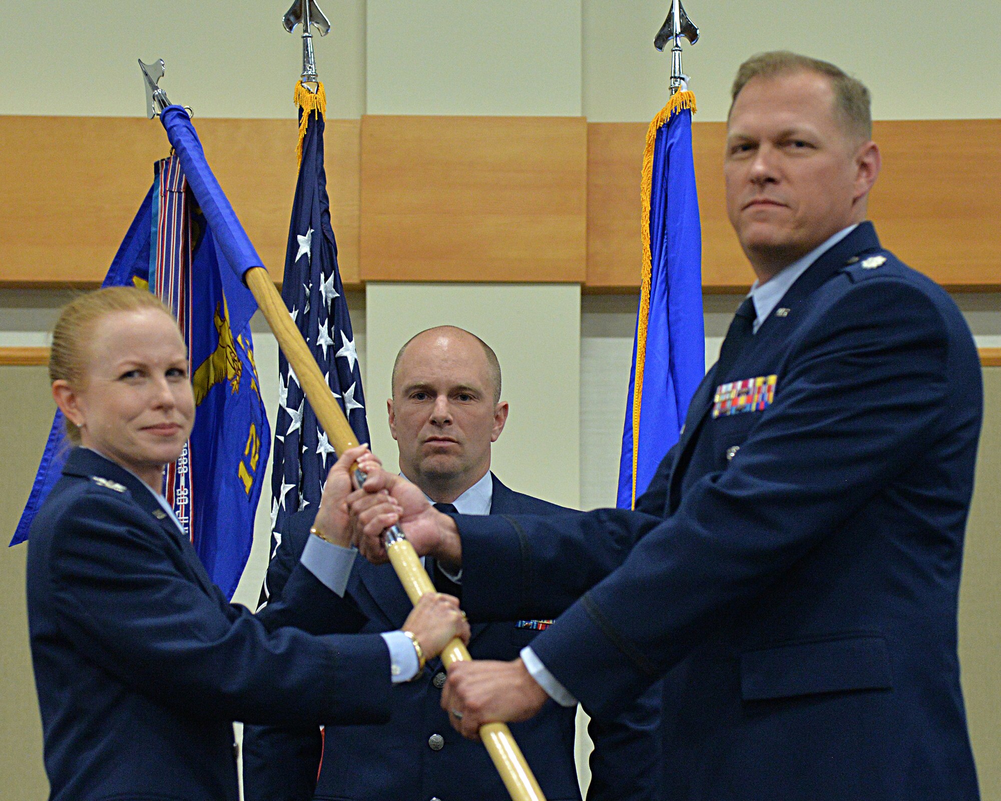 Lt. Col. Stephen Meister, right, accepts command of the 12th Missile Squadron from Col. Anita Feugate Opperman, 341st Operations Group commander during a change of command ceremony July 2, 2018, at the Grizzly Bend on Malmstrom AFB, Mont.