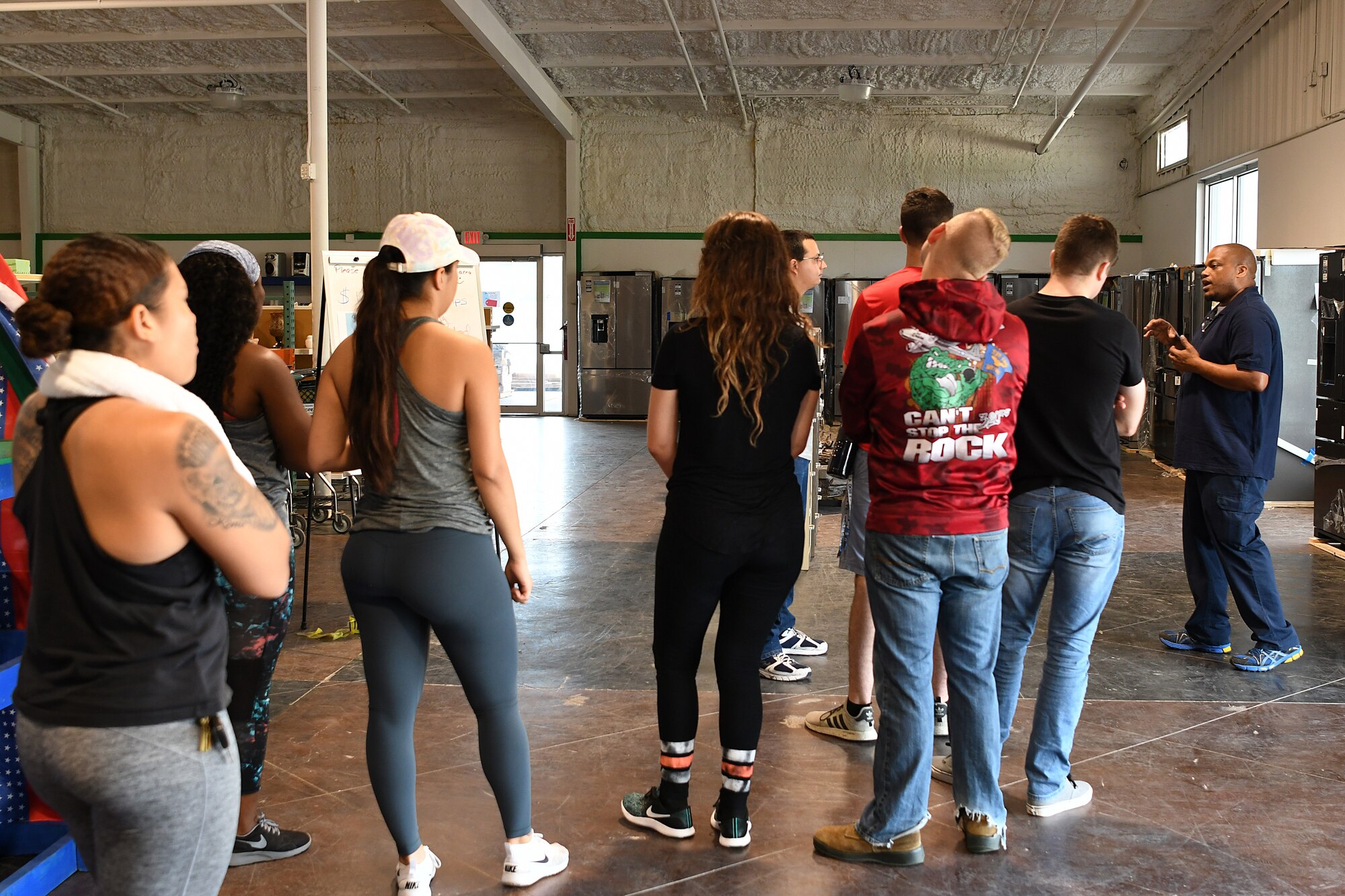 Muhammad Hardy, Habitat for Humanity restore operations specialist, right, briefs Keesler Airmen at the Habitat for Humanity Restore in Gulfport, Mississippi, June 28, 2018. This was a week-long volunteer event where Airmen helped restock, sort, clean, price and help customers at the store. In addition to the volunteer work Airmen do on their own in the community, Keesler Air Force Base organizes wing-wide volunteer events once a quarter to show their support to the surrounding community. (U.S. Air Force photo by Airman 1st Class Suzie Plotnikov)