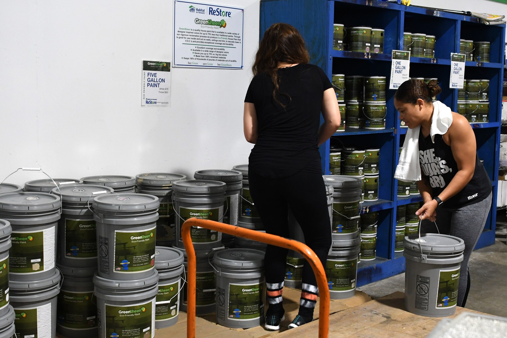 U.S. Air Force Airmen 1st Class Shauna Filomeo, 335th Training Squadron student, and Tenisha Washington, 81st Medical Support Squadron biomedical equipment technician, restock paint at the Habitat for Humanity Restore in Gulfport, Mississippi, June 28, 2018. This was a week-long volunteer event where Airmen helped restock, sort, clean, price and help customers at the store. In addition to the volunteer work Airmen do on their own in the community, Keesler Air Force Base organizes wing-wide volunteer events once a quarter to show their support to the surrounding community. (U.S. Air Force photo by Airman 1st Class Suzie Plotnikov)