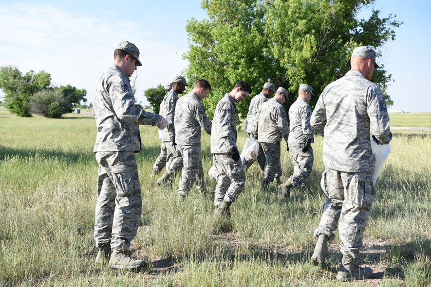 Airman from the 90th Maintenance Squadron walk alongside the road searching for debris during Mayoral Day June 29, 2018, on F.E. Warren Air Force Base, Wyo. Mayoral Day was part of a bigger day which included a cookout and commanders all-call. The purpose of setting aside time for Mayoral Day was to put forth extra effort to cleaning the base.