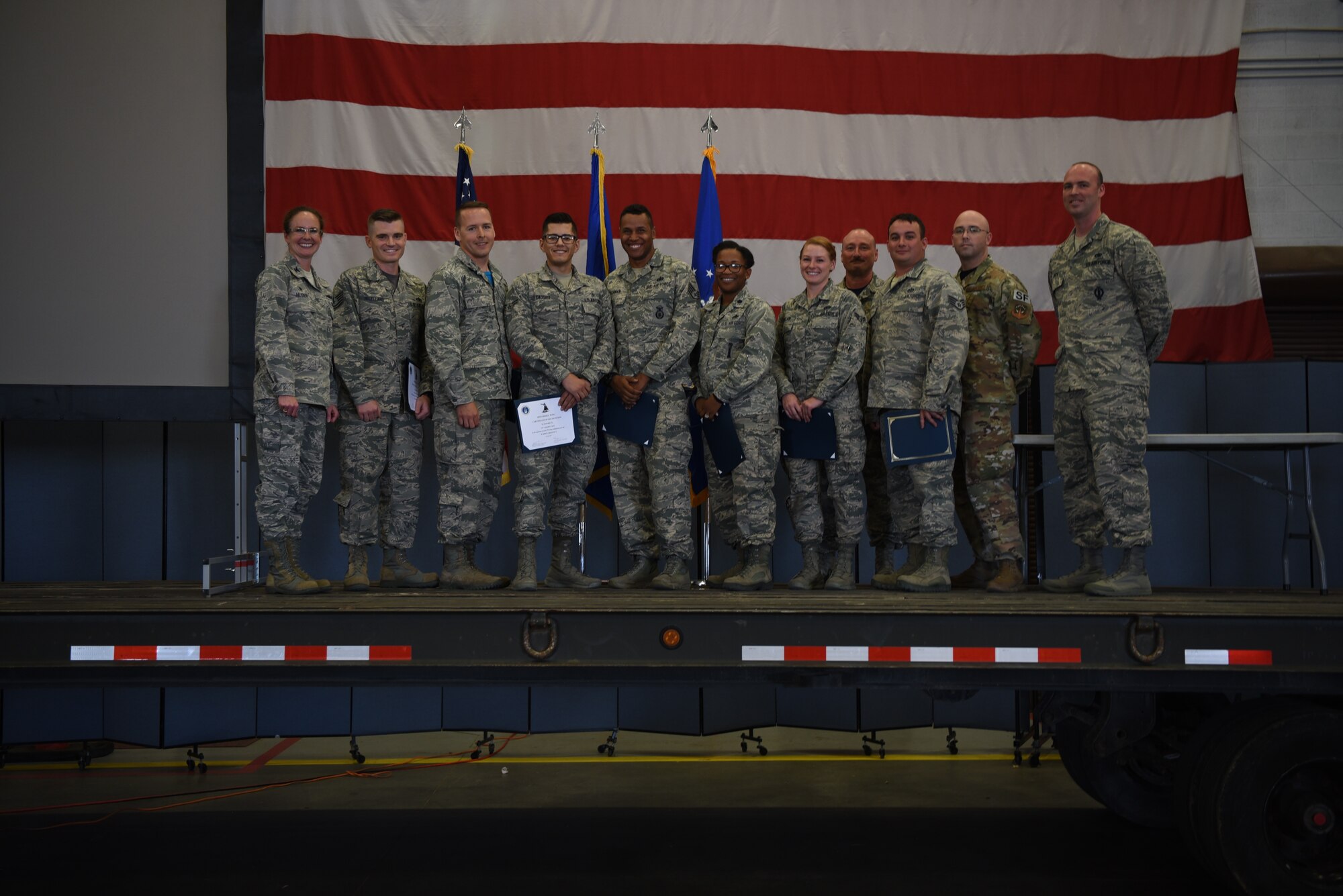 The winners of the Warren Shootout stand with the panel, Col. Stacy Jo Huser, 90th Missile Wing commander, and Chief Master Sgt. Kristian Farve, 90th Missile Wing command chief, during the award ceremony, June 29, 2018. The Warren Shootout was implemented to utilize squadron innovation funds for the wing to find Airmen-led innovative ideas that increase readiness, reduce cost, return time back to Airmen, and enhance the lethality of the force.