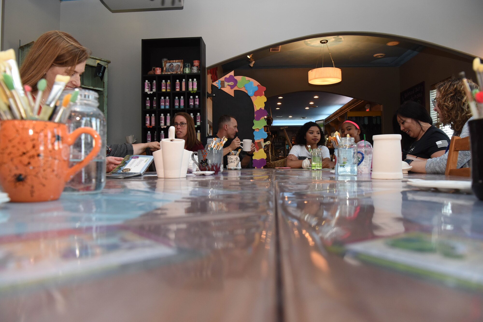 Spouses of deployed and remote Airmen along with members of the 28th Bomb Wing, paint pieces of pottery during a chapel event in Rapid City, S.D., June 26, 2018. The 28th BW Chapel offered a pottery painting activity which helped spouses get together and socialize in a safe environment. (U.S. Air Force photo by Airman 1st Class Thomas Karol)