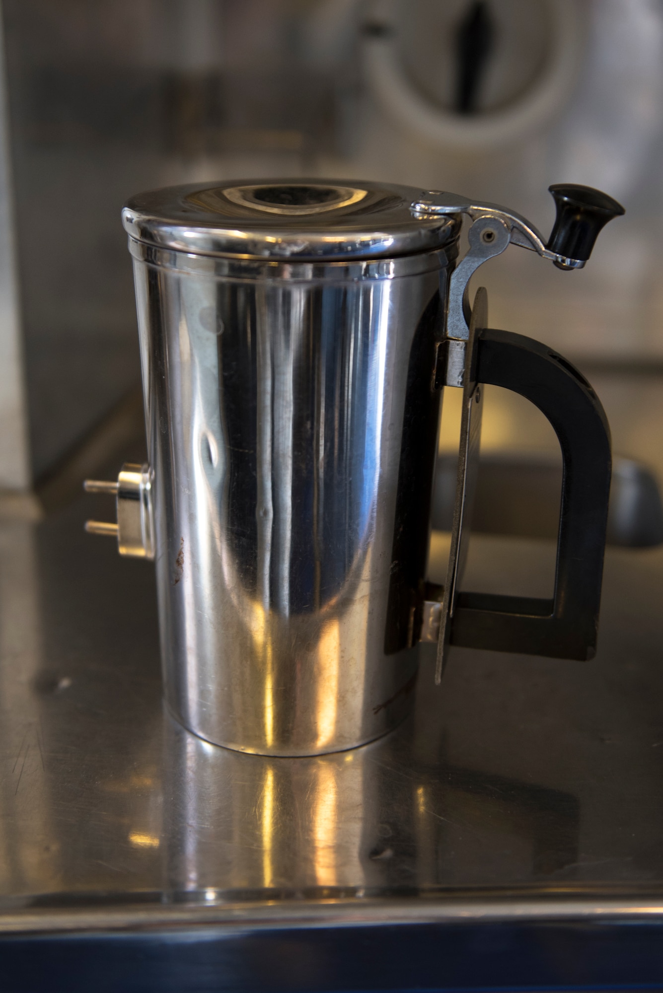 A hot cup sits on a counter inside a KC-10 Extender at Travis Air Force Base, Calif., June 21, 2018. The base is working on developing a new handle for the cup which could save the Air Force thousands. (U.S. Air Force photo by Tech. Sgt. James Hodgman)