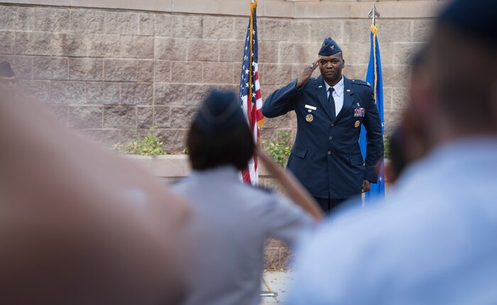 Col. Alfred Flowers Jr., 99th Medical Group commander, receives his first salute from Col. Suzie Dietz, 99th Inpatient Operations Squadron commander, during a change of command ceremony at Nellis Air Force Base, Nevada, June 29, 2018. The 99th MDG ensures medical care for more than 10,000 active duty personnel. (U.S. Air Force photo by Airman 1st Class Andrew D. Sarver)