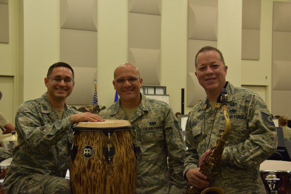 From left, U.S. Air Force Capt. Rafael Toro-Quiñones, commander and conductor of the Band of the Golden West, U.S. Air Force Staff Sgt. Wilfredo Cruz, on solo percussion and Tech. Sgt. Marco Muñoz, composer, pose for a photo during rehearsal at Travis Air Force Base, California, June 22, 2018. (U.S. Air Force photo by Senior Airman Mary Gant/Released)