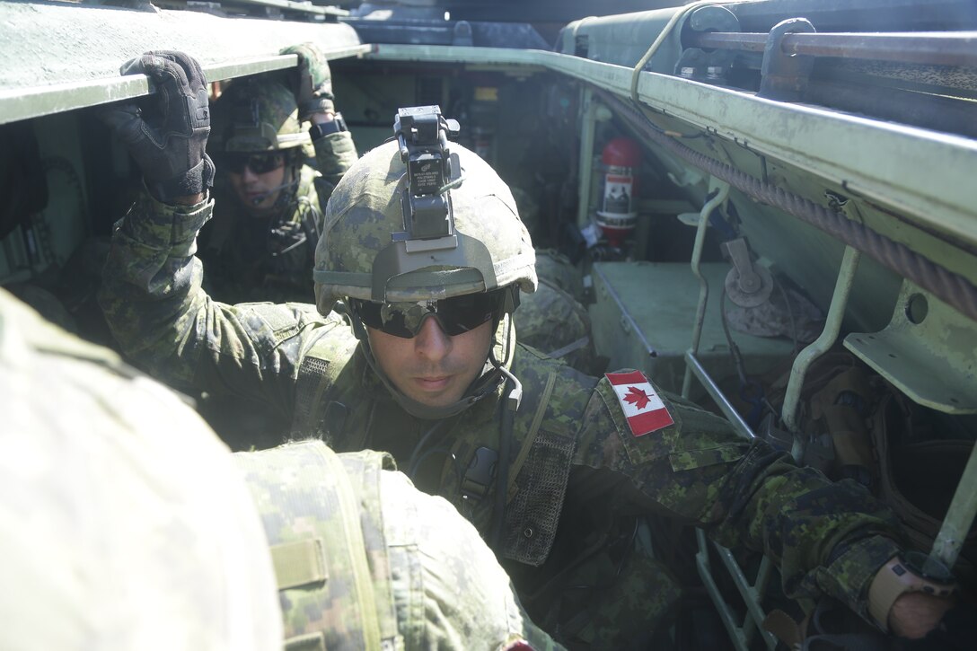 Canadian Armed Forces conduct egress drills at an assault amphibious vehicle familiarization training during Rim of the Pacific (RIMPAC) exercise at Marine Corps Base Camp Pendleton, California, June 28, 2018. Marines training with partner nations from around the world enhances prowess. RIMPAC provides high-value training for task-organized, highly-capable Marine Air-Ground Task Force and enhances the critical crisis response capability of U.S. Marines in the Pacific. (U.S. Marine Corps photo by Cpl. Jeremy Laboy)
