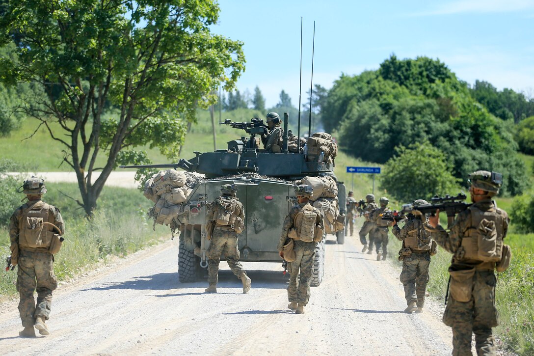 U.S. Marines from 1st Battalion, 6th Marines and 4th Light Armored Reconnaissance Battalion advance towards their objective during Exercise Saber Strike 18, near Skrunda, Latvia, June 10, 2018. Marines with Black Sea Rotational Force participated in Exercise Saber Strike, which is an integrated field-training exercise that occurs annually throughout Estonia, Latvia, Lithuania and Poland, increasing joint operational capability and enhancing the NATO alliance. (U.S. Marine Corps photo by Lance Cpl. Angel D. Travis/Released)