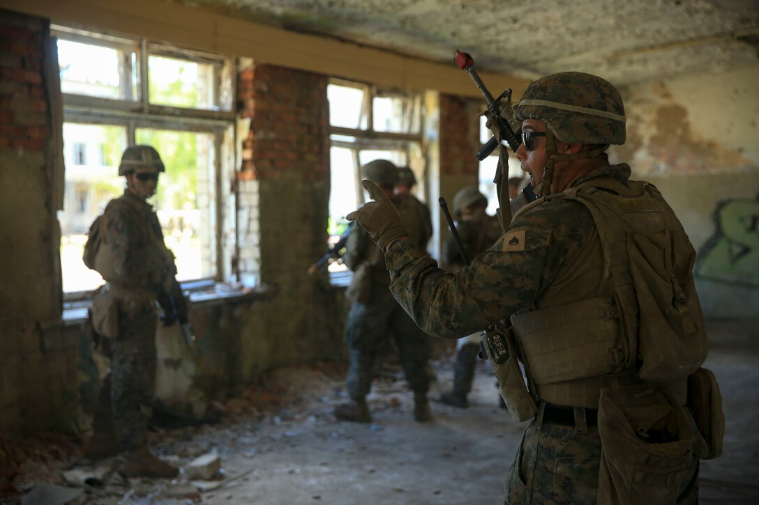 A U.S. Marine from 1st Battalion, 6th Marines issues orders during Exercise Saber Strike 18, in Skrunda, Latvia, June 13, 2018. Exercise Saber Strike is an integrated field-training exercise that occurs annually throughout Estonia, Latvia, Lithuania and Poland, increasing joint operational capability and enhancing the NATO alliance. (U.S. Marine Corps photo by Lance Cpl. Angel D. Travis/Released)