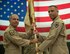 U.S. Air Force Lt. General Jeffrey L. Harrigian commander U.S. Air Force Central Command, hands the 380th Air Expeditionary Wing’s guidon to incoming Commander Brig. Gen. Adrian L. Spain during a change of command ceremony at Al Dhafra Air Base, July 2, 2018. (U.S. Air Force photo by Tech. Sgt. Nieko Carzis.)