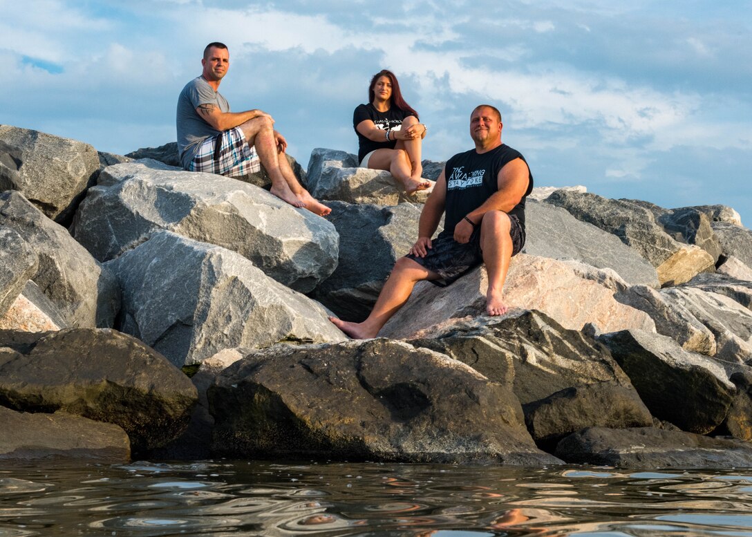 U.S. Air Force Tech. Sgt. Richard Penny, Ashley Staley and Adam Bradshaw sit on a rock bank on Fort Monroe Beach, Virginia, June 28, 2018, where they had saved a young girl from drowning earlier that year. Penny, Staley and Bradshaw rescued the girl from drowning near the rock bank on May 13, 2018 and received the Hampton, Virginia, Citizen Lifesaving certificate June 7, 2018. Penny works as the 633rd Air Base Wing Inspector General management internal control toolset administrator and special access program manager. (U.S. Air Force photo by Airman 1st Class Anthony Nin Leclerec)