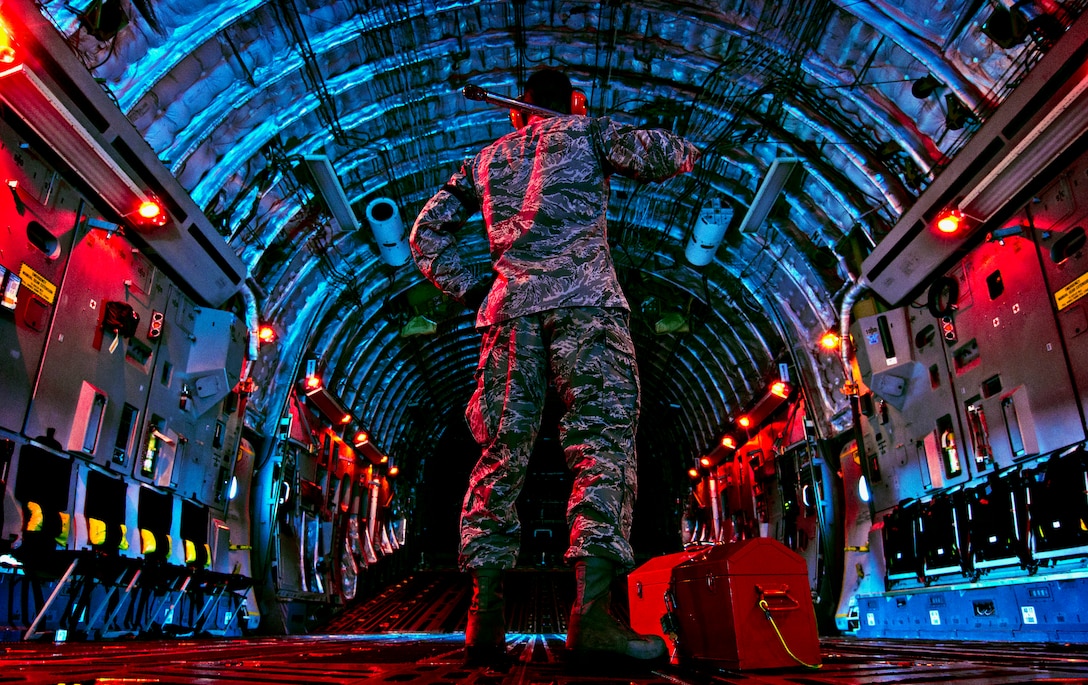 Senior Airman checks inside of C-17 Globemaster III before beginning preflight inspection March 27, 2013, at Wright-Patterson Air Force Base, Ohio (U.S. Air Force/Mikhail Berlin)