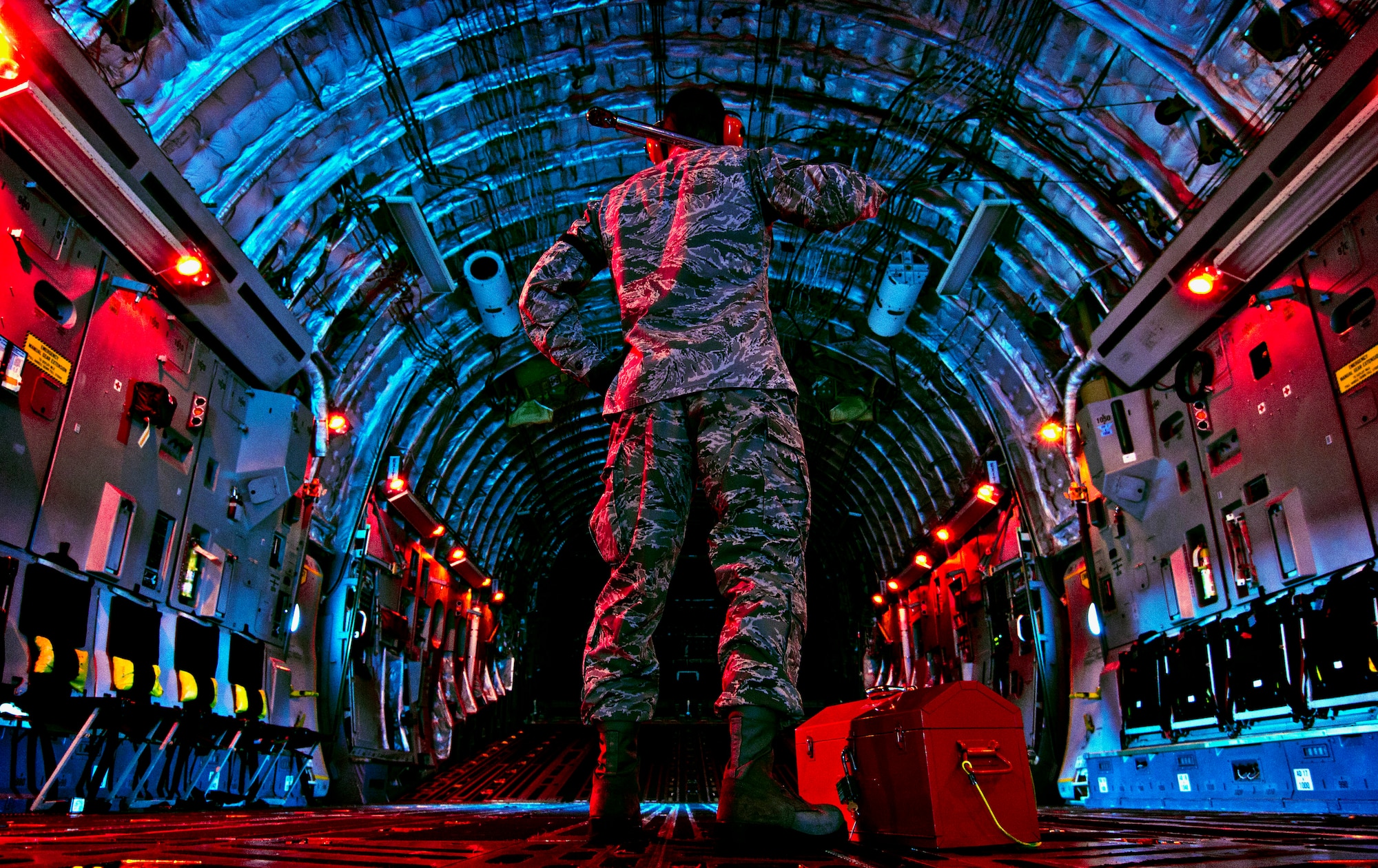 Senior Airman checks inside of C-17 Globemaster III before beginning preflight inspection March 27, 2013, at Wright-Patterson Air Force Base, Ohio (U.S. Air Force/Mikhail Berlin)