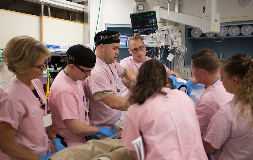 Maj. Shane Runyon, Baltimore’s Center for the Sustainment of Trauma and Readiness Skills (C-STARS) program deputy director, and Master Sgt. Sean Patterson, a respiratory therapist and superintendent of C-STARS Baltimore, work with staff and students on a newly arrived patient at the Trauma Resuscitation Unit (TRU) at the University of Maryland Medical Center, Baltimore, June 13, 2018. The U.S. Air Force’s C-STARS Baltimore program partners with the R Cowley Shock Trauma Center at the University of Maryland Medical Center to ensure medical Airmen train on the latest trauma care techniques by embedding them in the clinic and giving them first-hand experience treating trauma patients. (Courtesy photo)