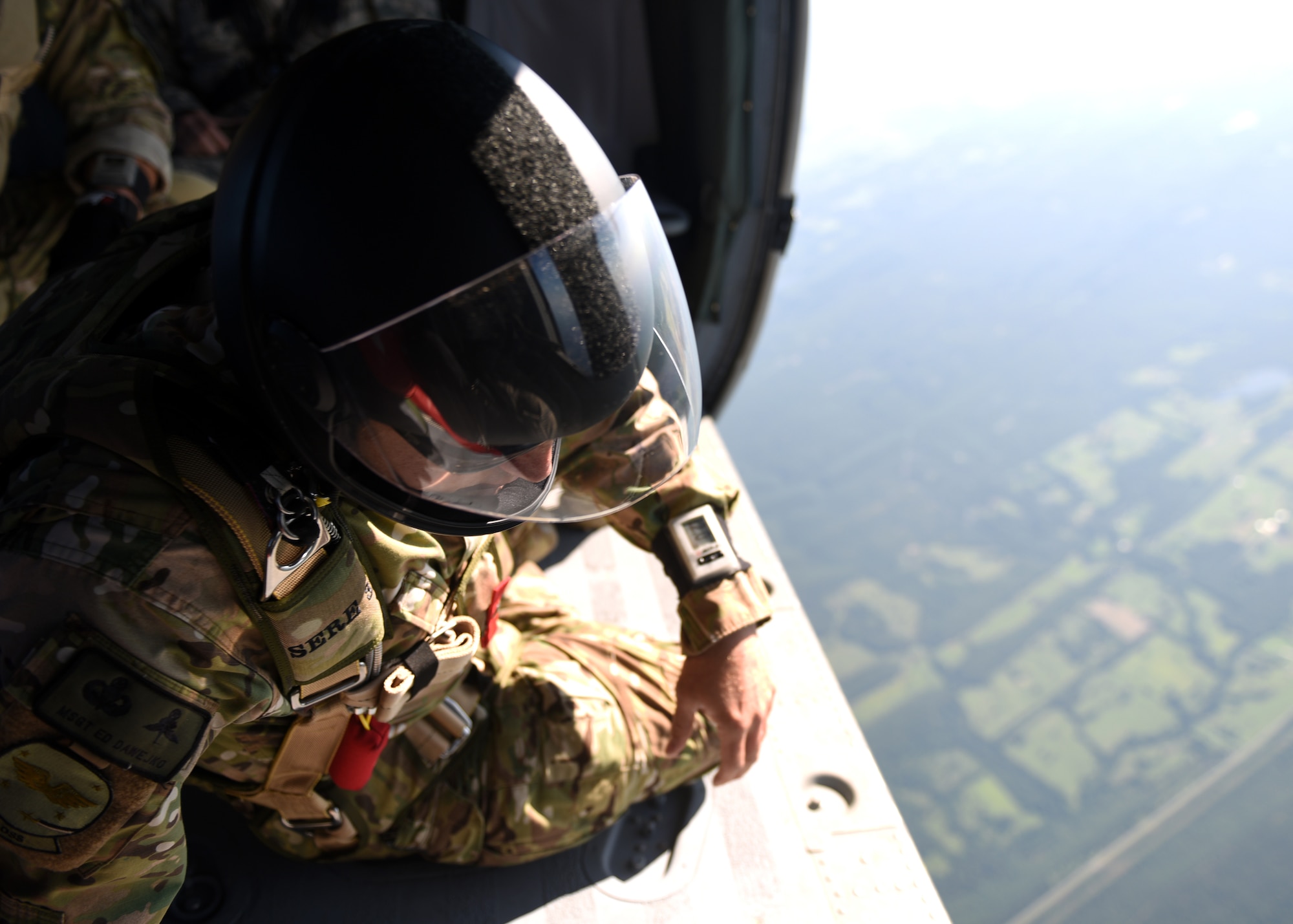People in uniform perform and prepare for freefall jumps.
