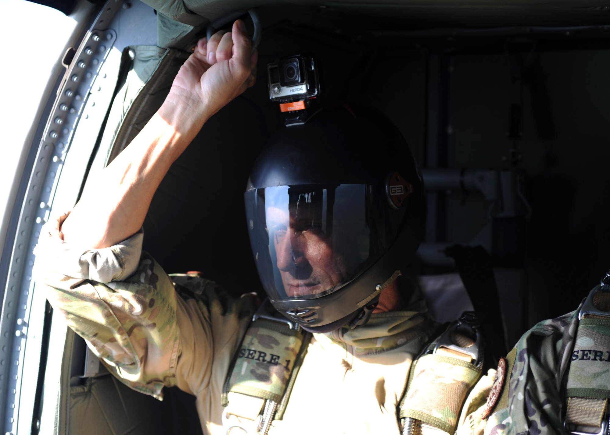 People in uniform perform and prepare for freefall jumps.