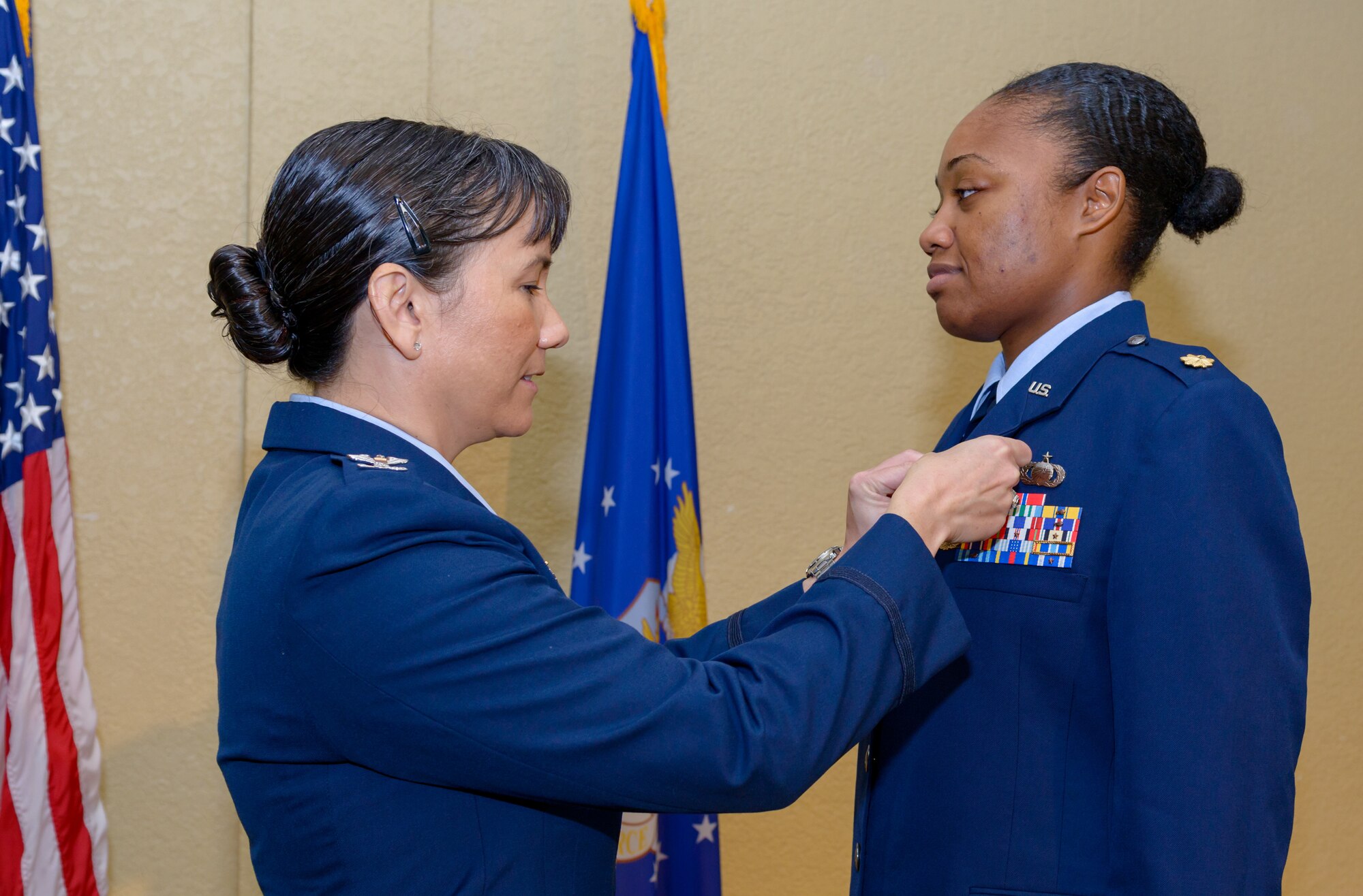 U.S. Air Force Col. Debra Lovette, 81st Training Wing commander, attaches the Meritorious Service Medal on the uniform of Maj. Jahayra Lowe, outgoing 81st Comptroller Squadron commander, during the 81st CPTS change of command ceremony in the Bay Breeze Event Center at Keesler Air Force Base, Mississippi, June 29, 2018.  The medal was awarded to Lowe based on the squadron’s accomplishments under her leadership.  (U.S. Air Force photo by Andre’ Askew)