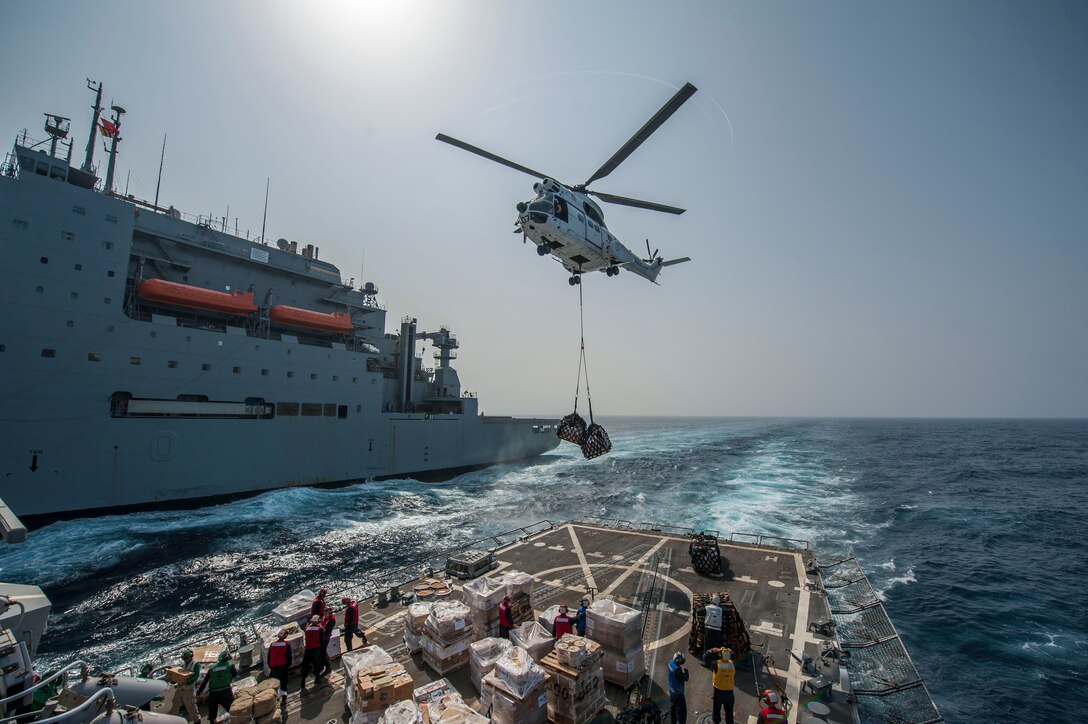SA-330J Puma helicopter drops supplies on flight deck of USS Truxtun during vertical replenishment with Military Sealift Command dry cargo and ammunition ship USNS Richard E. Byrd, Red Sea, April 12, 2014 (U.S. Navy/Scott Barnes)