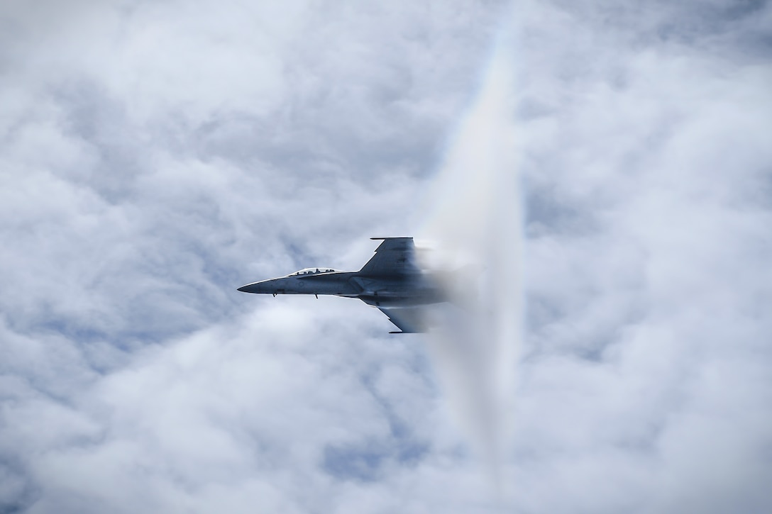 F/A-18F Super Hornet, assigned to Fighting Redcocks of Strike Fighter Attack Squadron (VFA) 22, breaks sound barrier over aircraft carrier USS Theodore Roosevelt during airpower demonstration, Pacific Ocean, May 3, 2018 (U.S. Navy/Spencer Roberts)