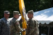 Lt. Gen. Jeffrey Buchanan (right) passes the Joint Task Force Civil Support (JTF-CS) flag to Maj. Gen. William Hall (left) during a change of command ceremony held at Seay Plaza on Fort Eustis. The passing of the flag symbolizes the passing of authority from one commander to another. Hall assumed authority of JTF-CS from Maj. Gen. Richard Gallant June 29, and is now JTF-CS’s tenth commanding general. (Official DoD photo by Christopher Thompson/released)