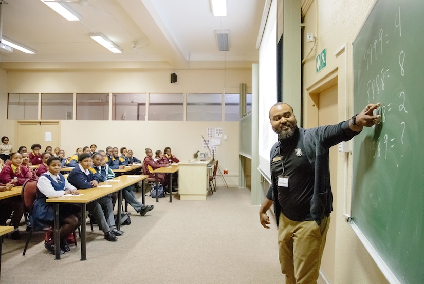 Professor teaches South African students in classroom.