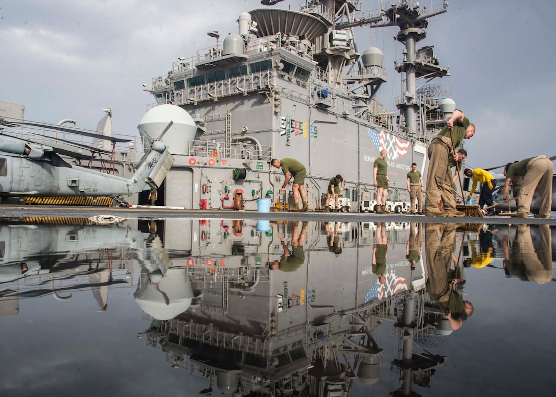Sailors and Marines participate in flight deck washdown aboard USS Iwo Jima, May 7, 2018 (U.S. Navy/Dominick A. Cremeans)